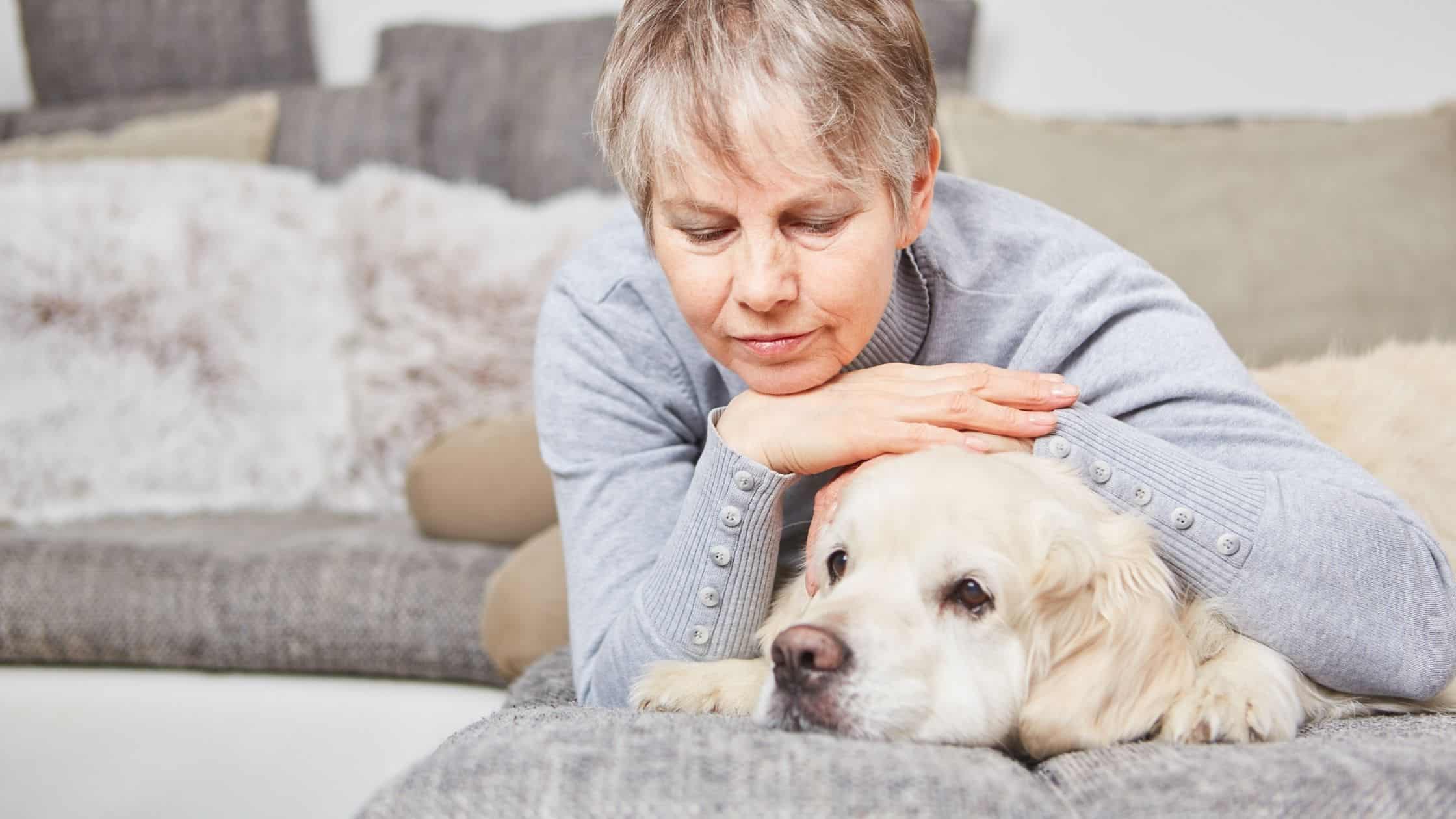 Older women petting senior dog