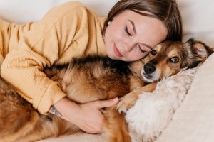 Woman cuddling with her dog
