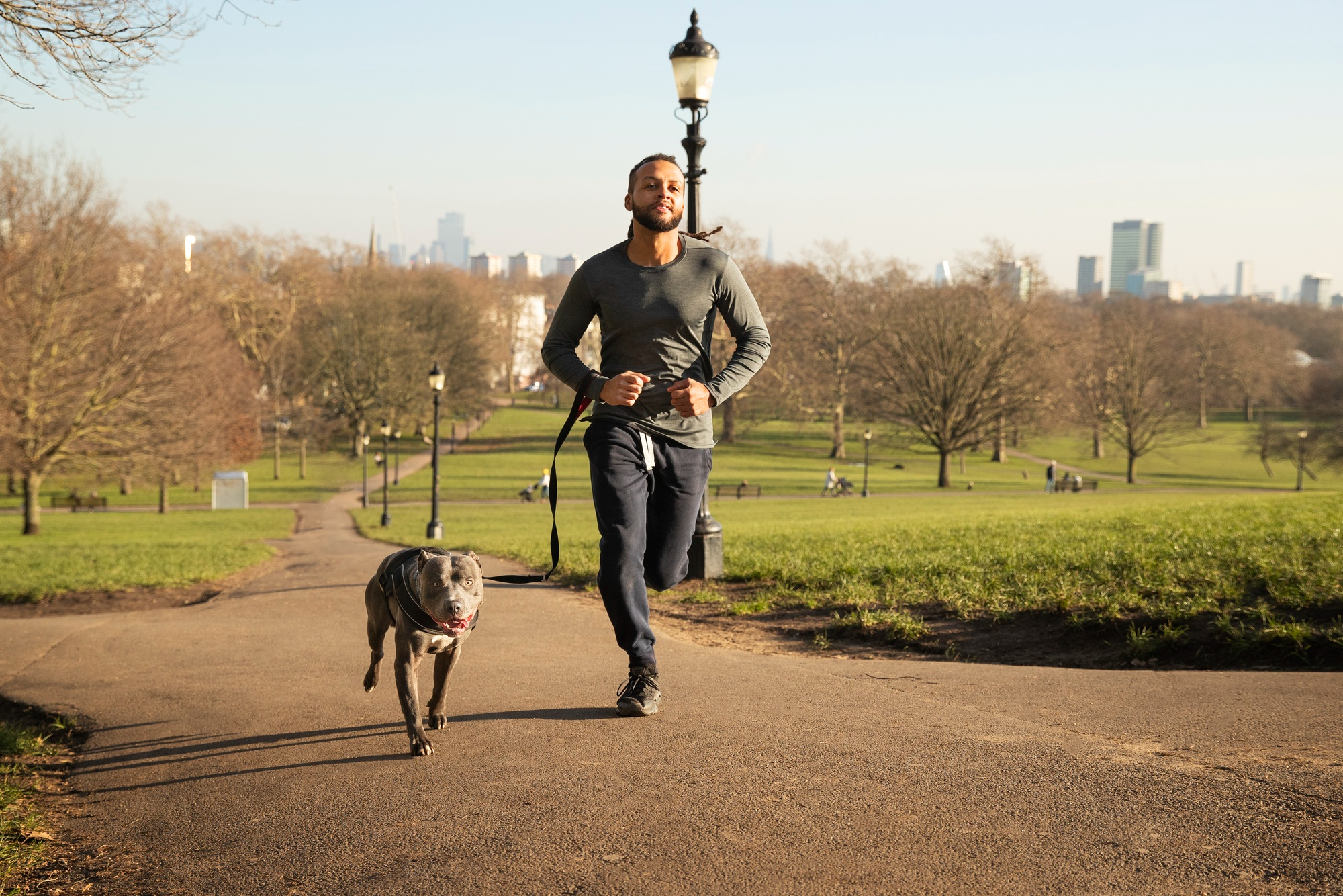 Full shot man running with dog outdoors Approximately half of American dogs are overweight and that number that has climbed steadily over the past two decades.